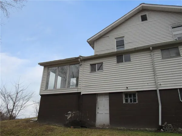 a view of house with backyard