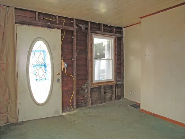 an empty room with window mirror and windows