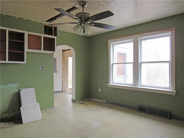 a view of a livingroom with a ceiling fan and window