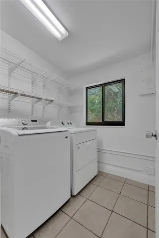 a utility room with cabinets washer and dryer
