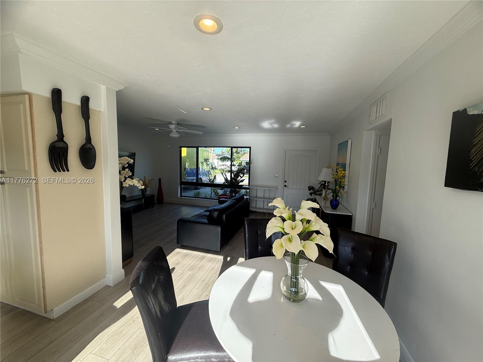 5001 Northeast 23rd Avenue Lighthouse Point, FL 33064 - Photo 15 of 49 a living room with furniture and a chandelier