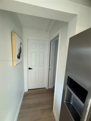 a view of an empty room and wooden floor