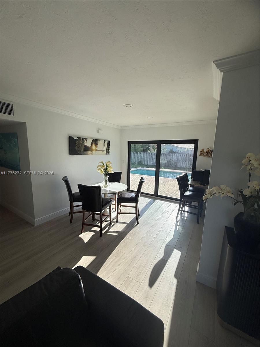 5001 Northeast 23rd Avenue Lighthouse Point, FL 33064 - Photo 22 of 49 a dining room with furniture and window