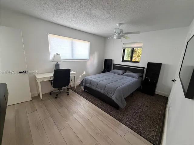 a dining room with furniture window and wooden floor