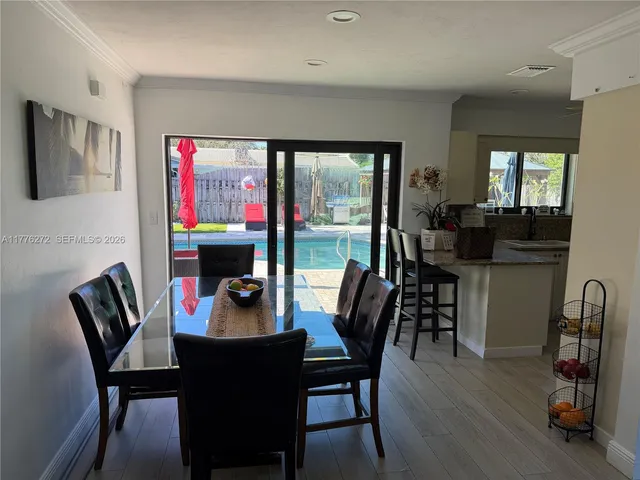 a view of a dining room with furniture window and wooden floor