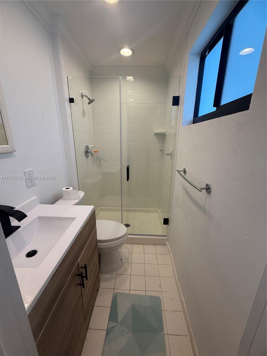 5001 Northeast 23rd Avenue Lighthouse Point, FL 33064 - Photo 27 of 49 a bathroom with a sink a toilet and shower