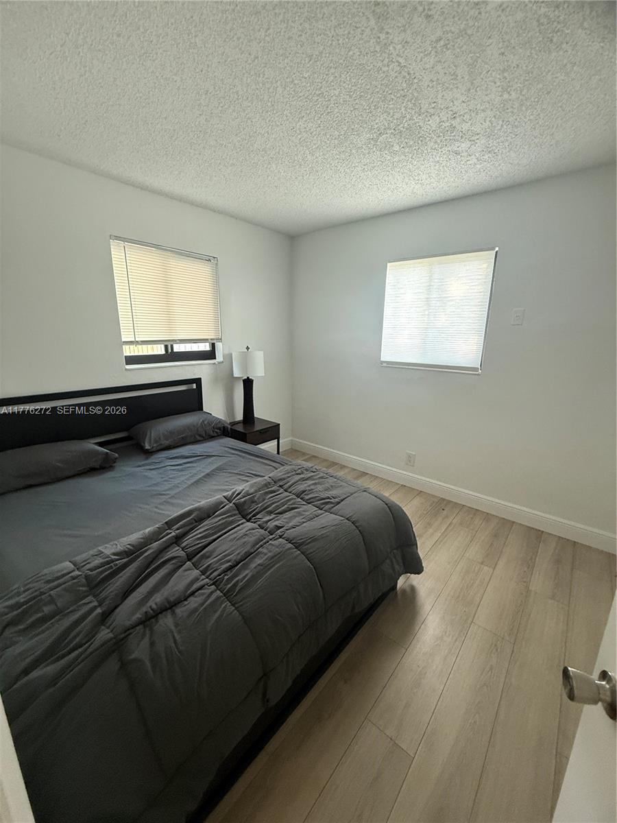 5001 Northeast 23rd Avenue Lighthouse Point, FL 33064 - Photo 28 of 49 a bedroom with a bed and a window