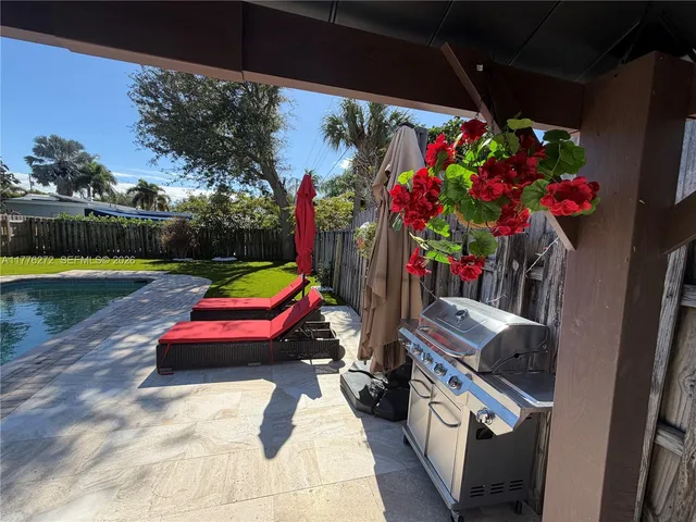 a view of a backyard with swimming pool