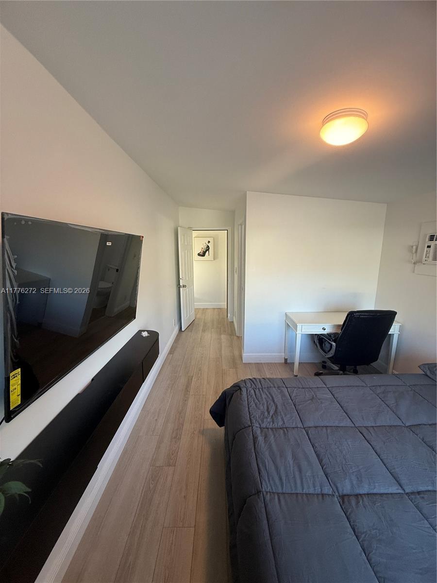 5001 Northeast 23rd Avenue Lighthouse Point, FL 33064 - Photo 32 of 49 a bedroom with a bed and a television