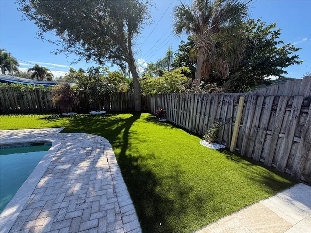 a view of a swimming pool with a yard