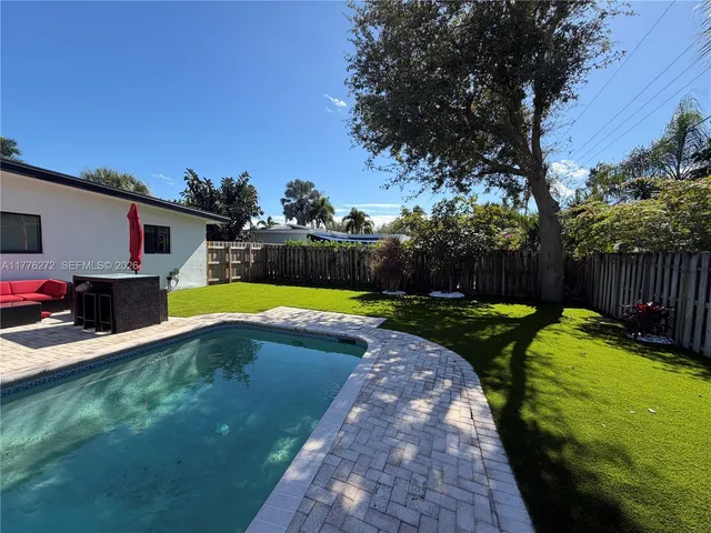 a view of a backyard with swimming pool
