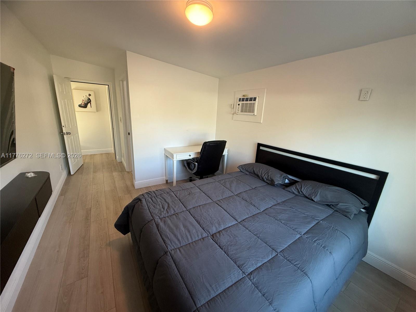 5001 Northeast 23rd Avenue Lighthouse Point, FL 33064 - Photo 34 of 49 a bedroom with a bed and a lamp on table