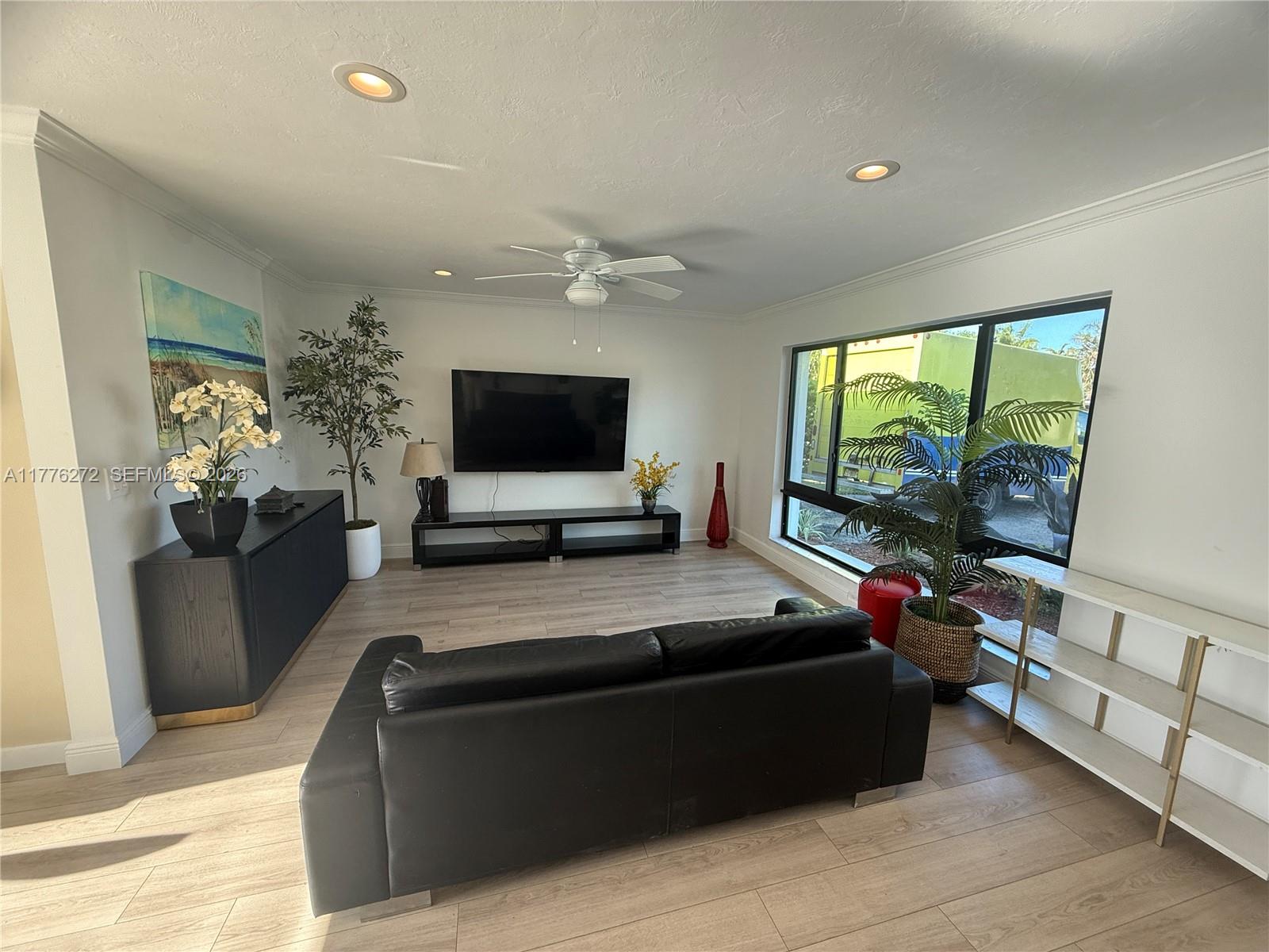 5001 Northeast 23rd Avenue Lighthouse Point, FL 33064 - Photo 4 of 49 a living room with furniture and a flat screen tv