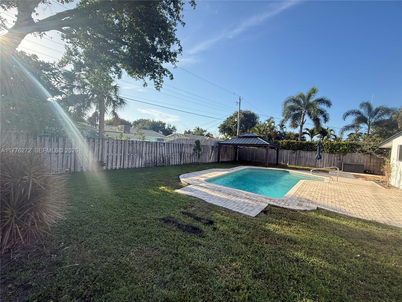 5001 Northeast 23rd Avenue Lighthouse Point, FL 33064 - Photo 42 of 49 a view of a backyard with wooden fence