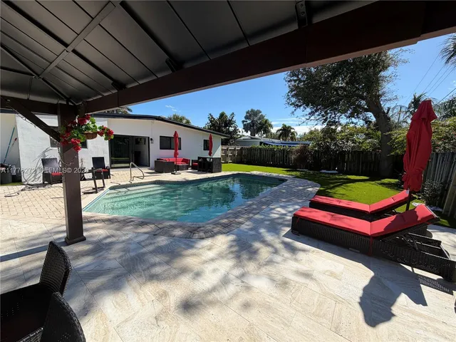 a view of a backyard with a car parked