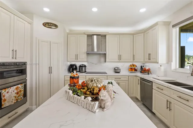 a kitchen with sink refrigerator and window
