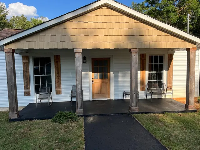 a view of brick house with large windows