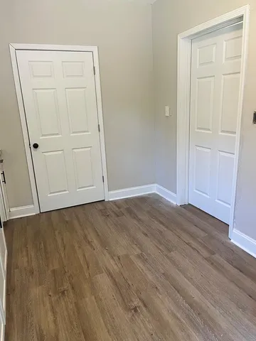 an empty room with wooden floor