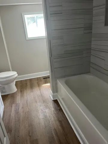 a bathroom with a bathtub and a toilet