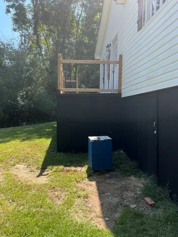 a backyard of a house with barbeque oven