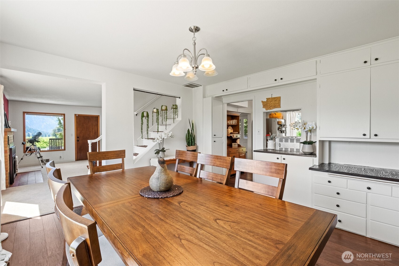 9753 Nibbelink Road Peshastin, WA 98847 - Photo 6 of 35 a view of a dining room with furniture a chandelier and wooden floor