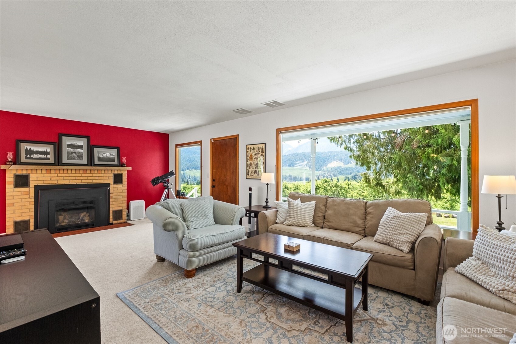 9753 Nibbelink Road Peshastin, WA 98847 - Photo 8 of 35 a living room with furniture a fireplace and a large window