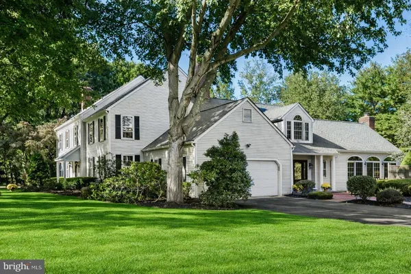 a front view of a house with a garden and yard