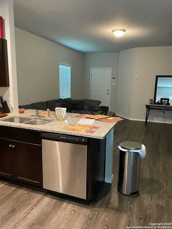 a kitchen with a sink and a stove top oven