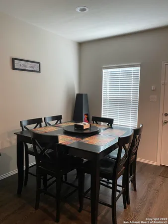 a view of a dining room with a table and chairs