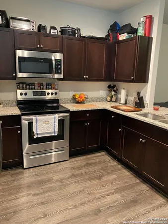 a kitchen with wooden cabinets and a stove top oven