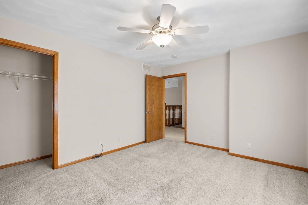 154 Rivers Edge Drive Cherry Valley, IL 61016 - Photo 15 of 32 an empty room with closet and a ceiling fan