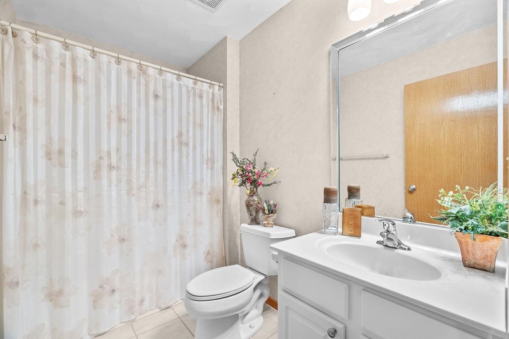 154 Rivers Edge Drive Cherry Valley, IL 61016 - Photo 16 of 32 a bathroom with a sink a toilet and a mirror