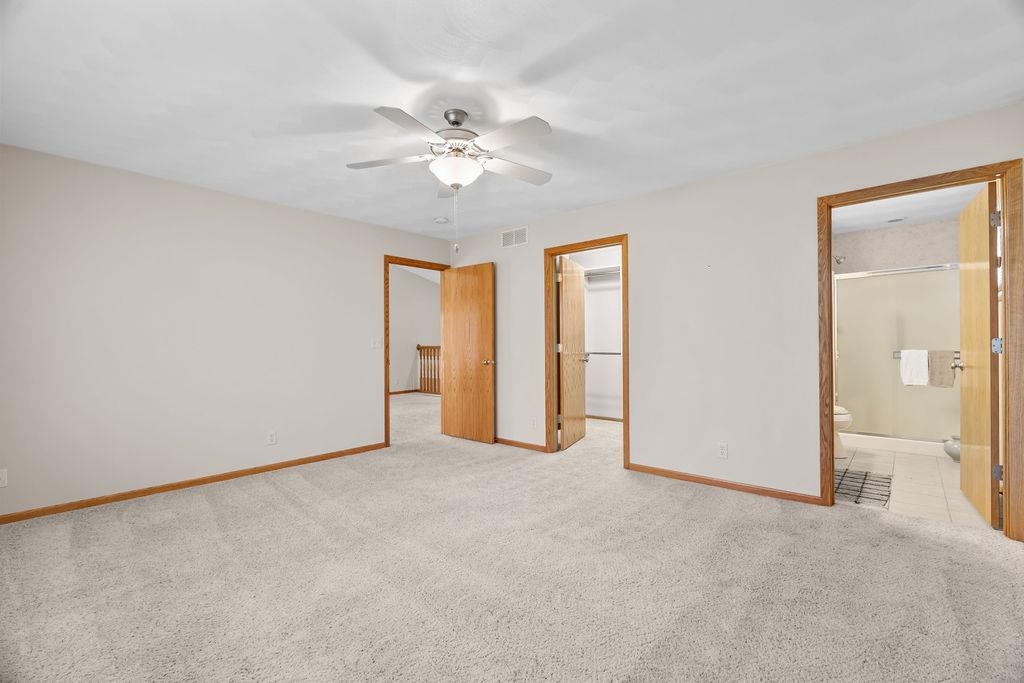 154 Rivers Edge Drive Cherry Valley, IL 61016 - Photo 17 of 32 an empty room with closet and a chandelier fan