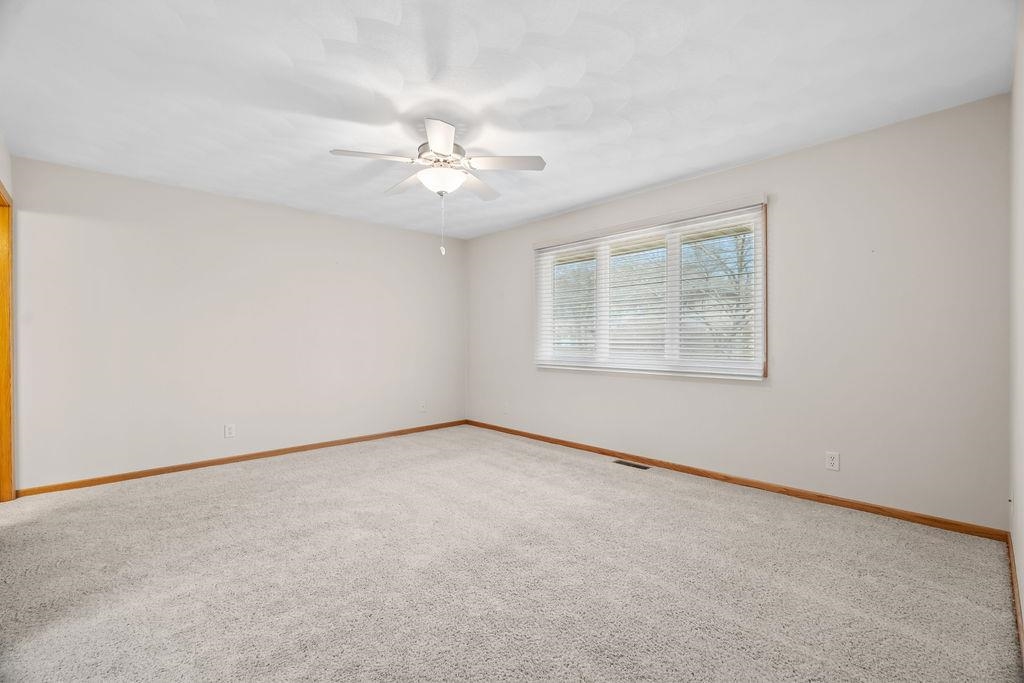 154 Rivers Edge Drive Cherry Valley, IL 61016 - Photo 18 of 32 an empty room with windows and fan