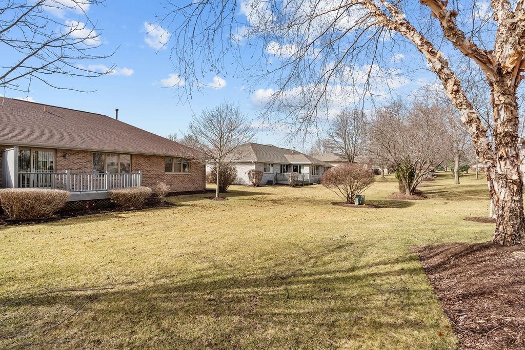 154 Rivers Edge Drive Cherry Valley, IL 61016 - Photo 29 of 32 a front view of a house with a yard covered with snow and trees
