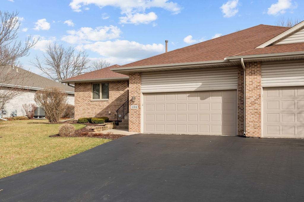 154 Rivers Edge Drive Cherry Valley, IL 61016 - Photo 3 of 32 a view of the house with backyard and parking