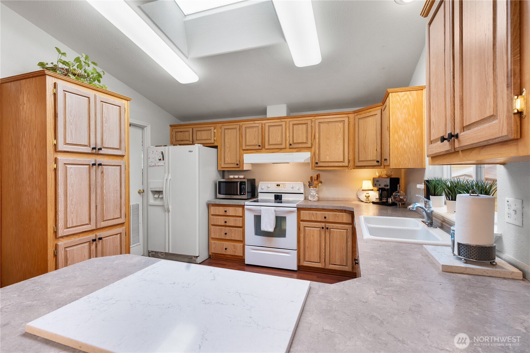 23825 15th Avenue Southeast, Unit 40 Bothell, WA 98021 - Photo 12 of 39 a kitchen with a refrigerator sink and cabinets
