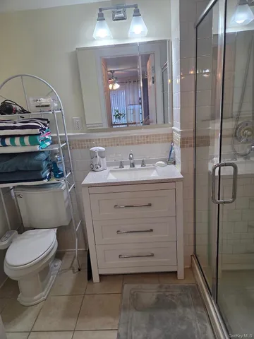 a bathroom with a toilet sink and shower