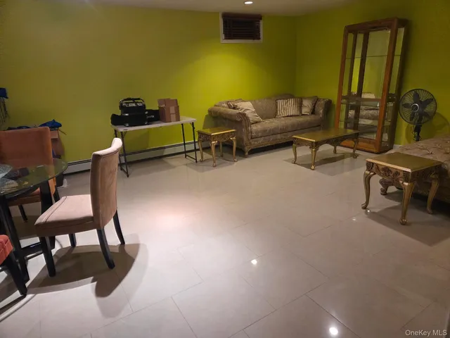 a spacious bedroom with a bed and a painting on the wall