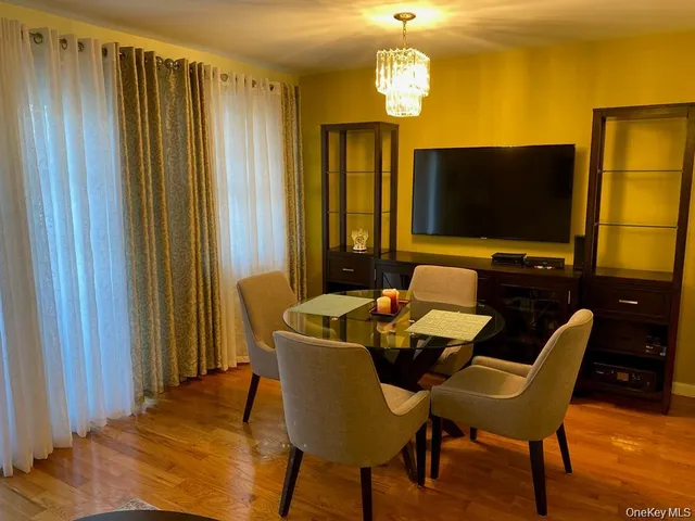 a view of a dining room with furniture and a chandelier