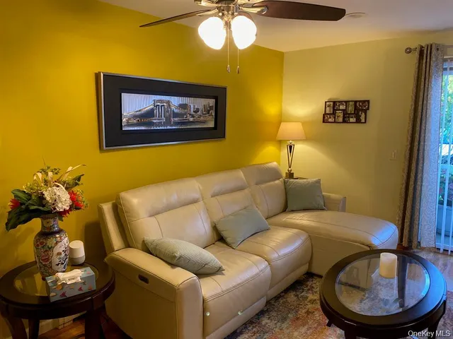a living room with furniture and a mirror