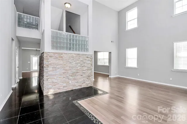 a view of an entryway of wooden floor and a living room