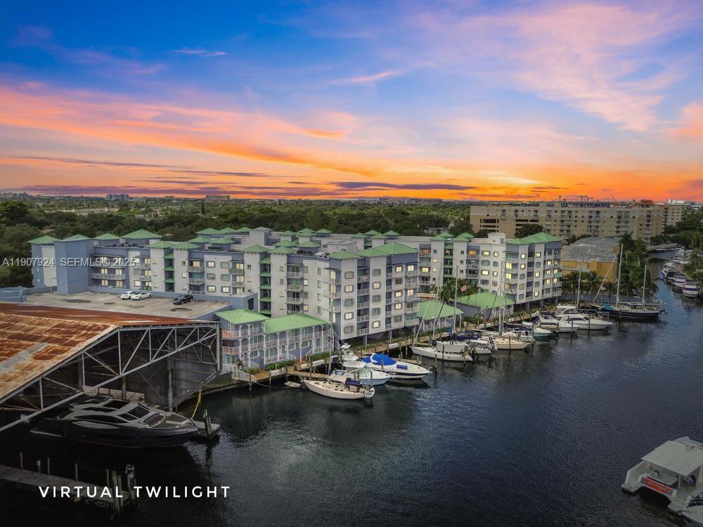 2475 Northwest 16th St Road, Unit 616 Miami, FL 33125 - Photo 1 of 32 a view of water with boats and trees in the background