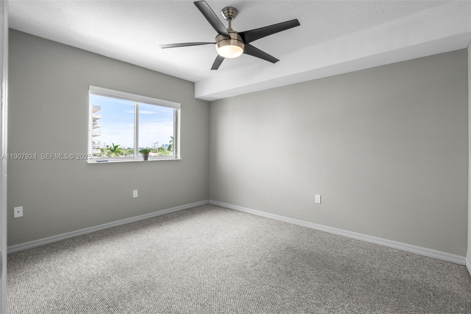 2475 Northwest 16th St Road, Unit 616 Miami, FL 33125 - Photo 22 of 32 an empty room with a window and a fan