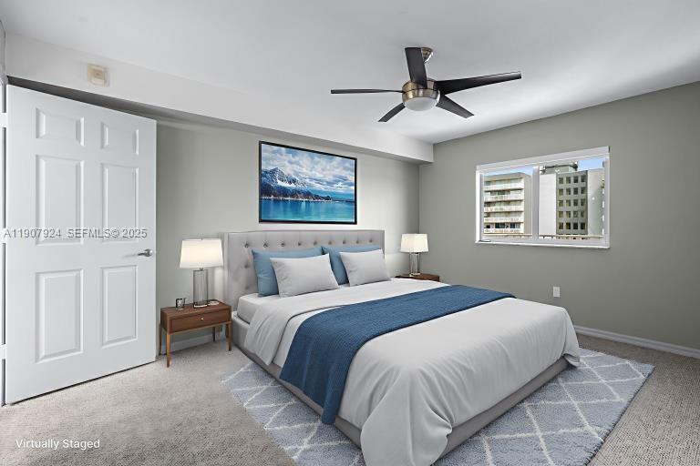 2475 Northwest 16th St Road, Unit 616 Miami, FL 33125 - Photo 26 of 32 a bedroom with a large bed and a chandelier