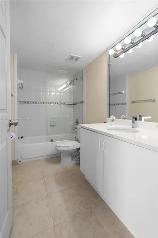 a bathroom with a double vanity sink toilet and shower