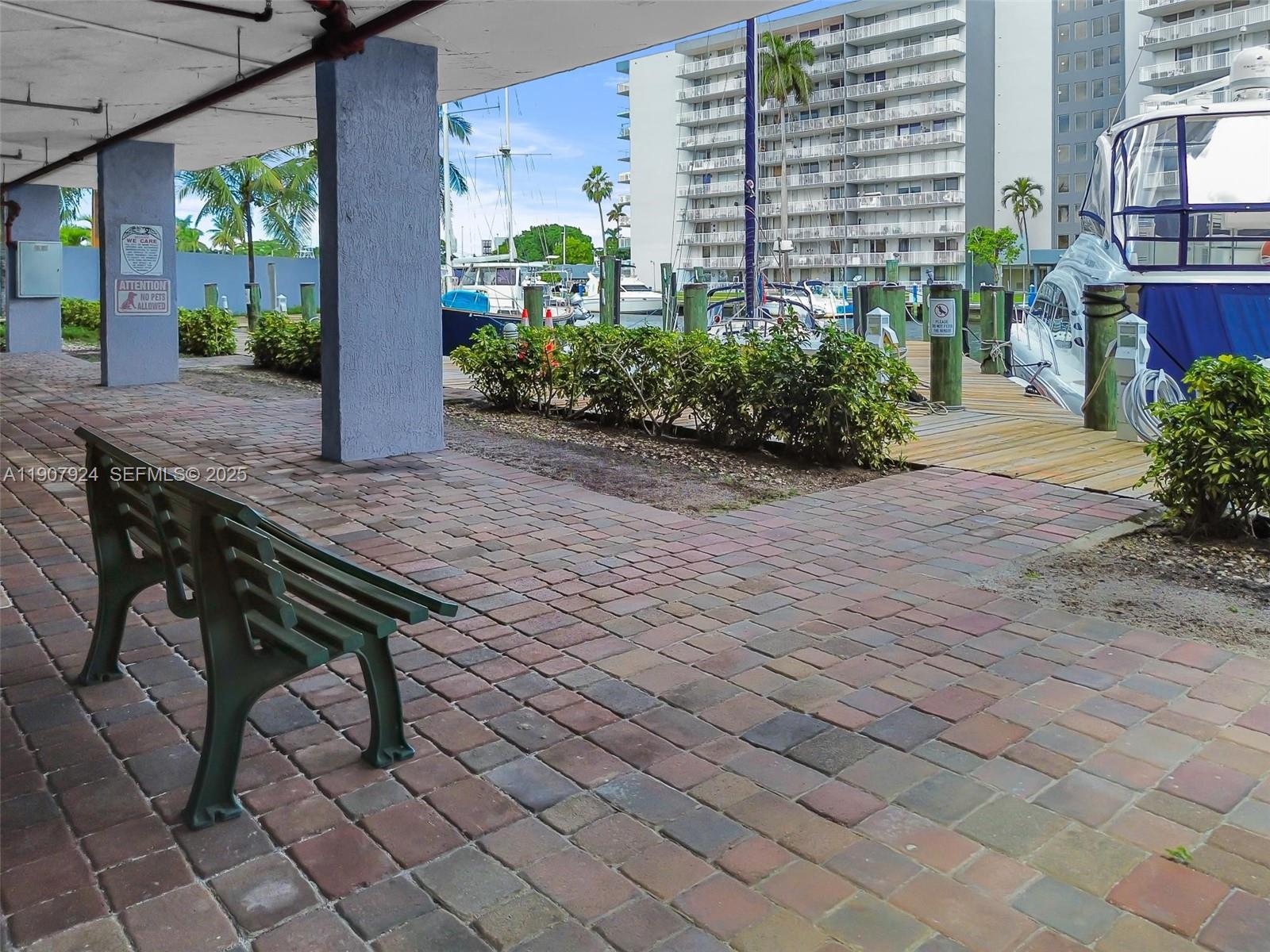 2475 Northwest 16th St Road, Unit 616 Miami, FL 33125 - Photo 29 of 32 a wooden bench sitting in front of a building