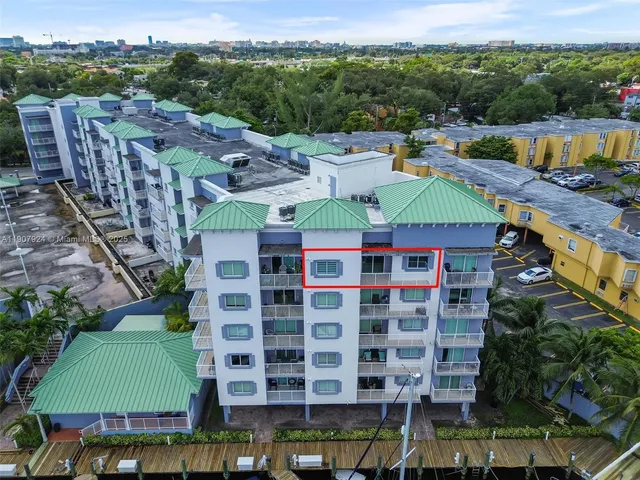 a view of a city that has tall buildings and a big yard