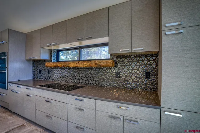 a kitchen with stainless steel appliances granite countertop a sink and a stove