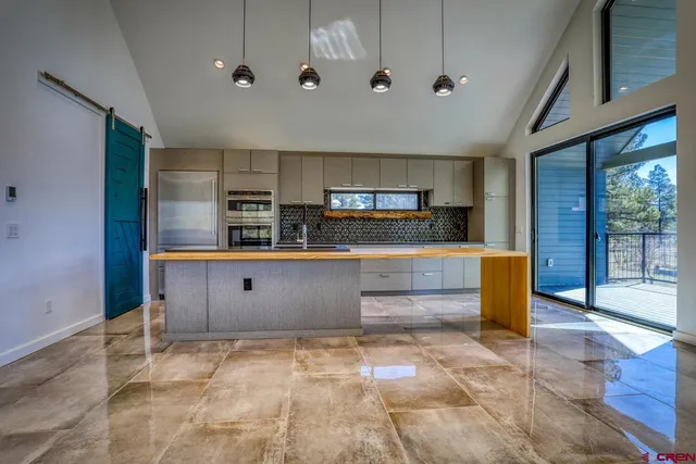 a view of kitchen with stainless steel appliances cabinets and outdoor space